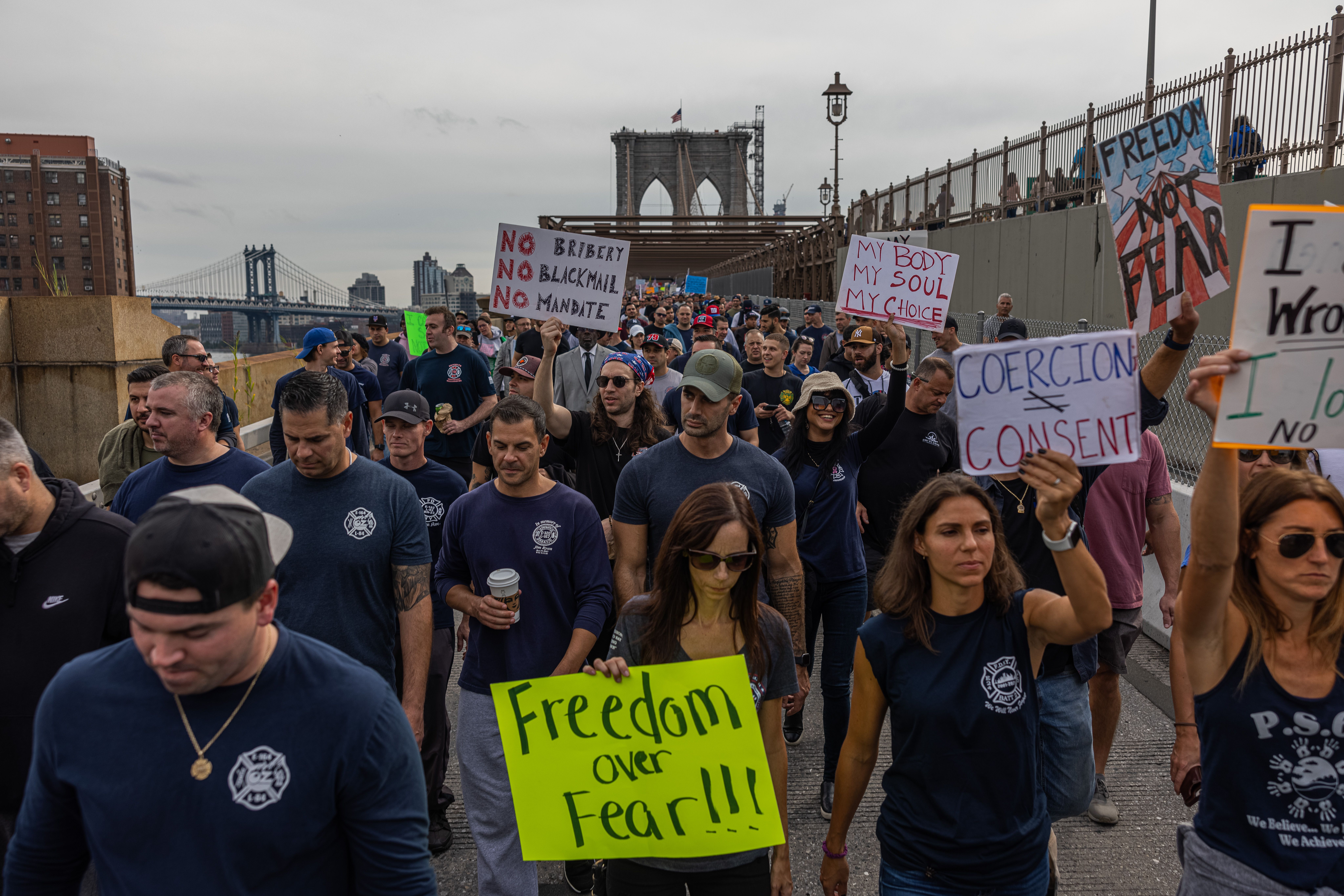 Thousands of municipal workers gather across the Brooklyn Bridge and around City Hall to protest the vaccine mandate